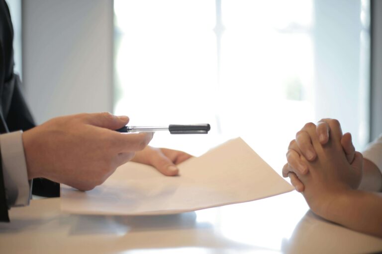 General Credit Finance and Development Limited staff holding a pen and document in the office, reviewing project details
